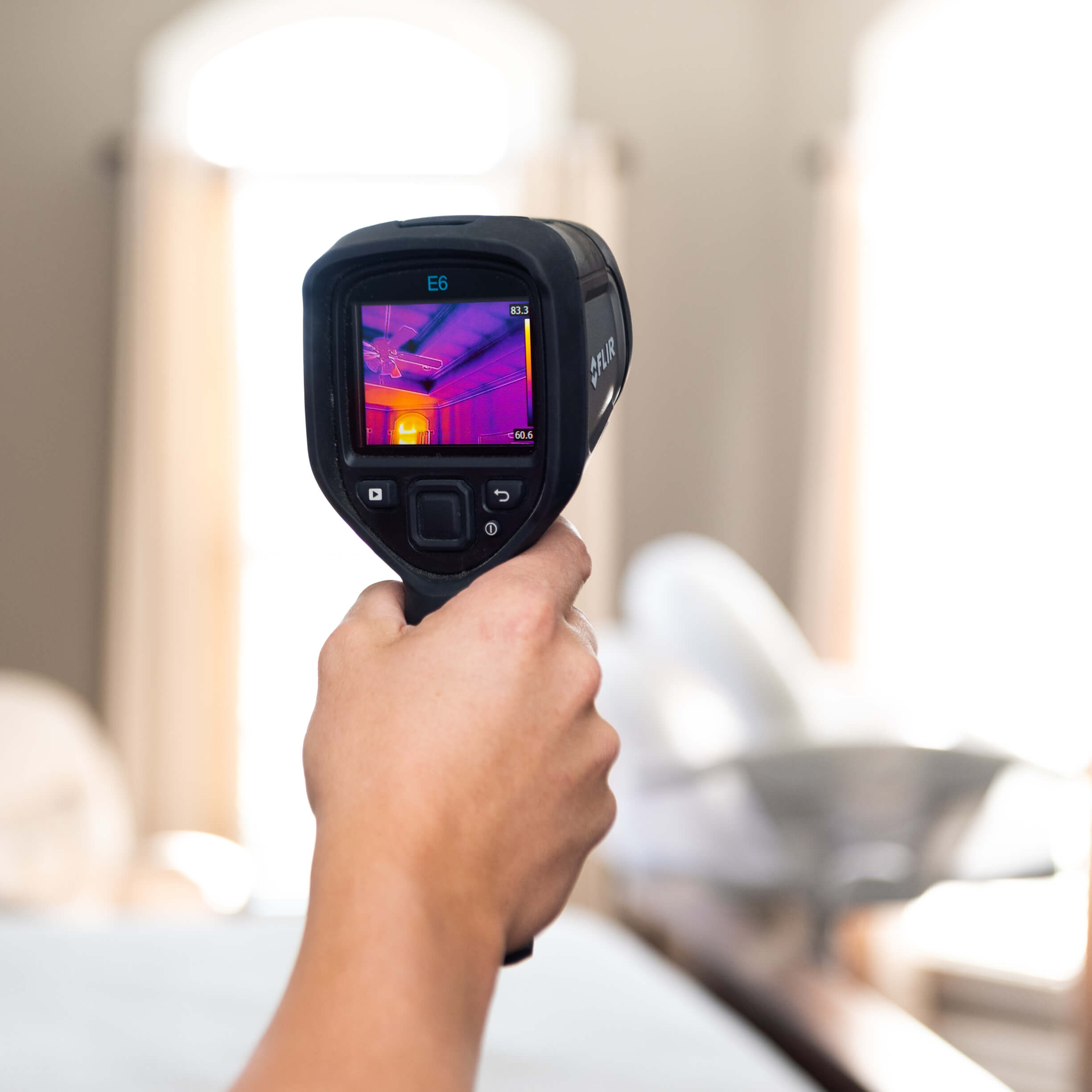 home inspector with a thermal camera